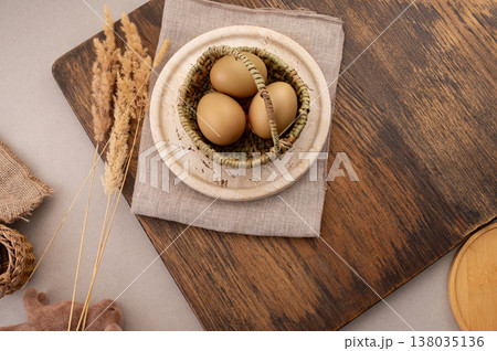 Easter eggs decorated with natural materials, travertine plate and background. 138035136