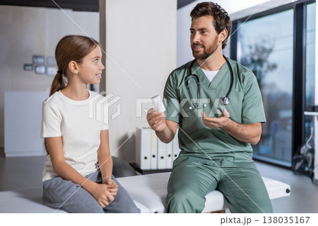 Specialist explaining medication plan to young patient 138035167