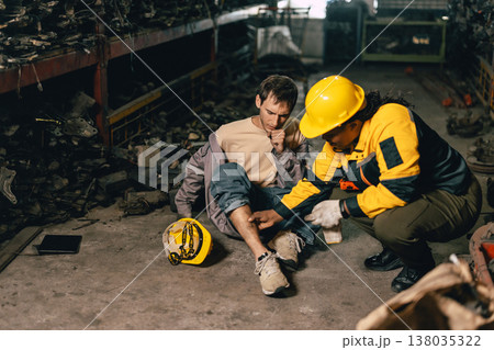 Supervisor working medical emergency first aid help employee staff accident at workplace, leg injury 138035322
