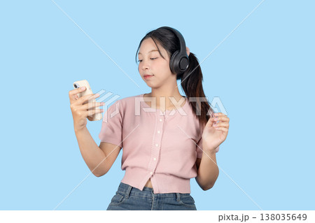 young teen girl happy smile enjoy music from phone, listening music by headphone studio isolated 138035649