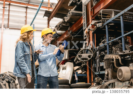 Technician male worker working in garage scrap yard old car part workshop warehouse Technician male worker working in garage scrap yard old car part workshop warehouse 138035795