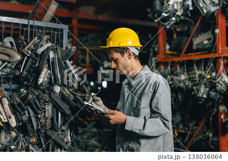Technician male worker working in garage scrap yard old car part workshop warehouse Technician male worker working in garage scrap yard old car part workshop warehouse 138036064