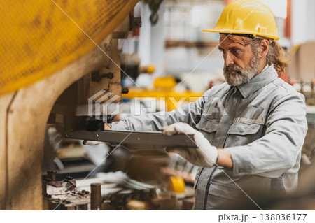 Senior engineer high precision look at product for quality control, professional work in metal sheet factory 138036177