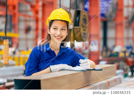 Young Asian woman engineer worker happy smiling professional working in metal sheet plant factory Young Asian woman engineer worker happy smiling professional working in metal sheet plant factory 138036335