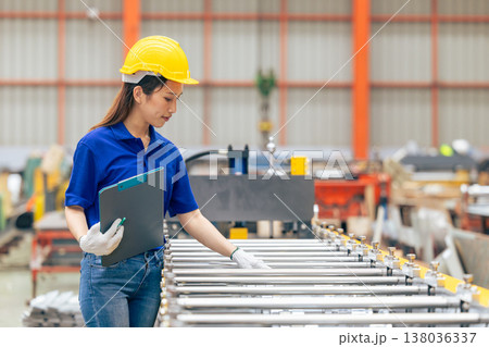 Young Asian woman teen engineer worker, professional working check machine in metal sheet factory Young Asian woman teen engineer worker, professional working check machine in metal sheet factory 138036337
