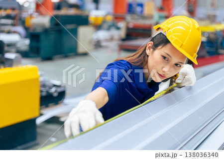 Young Asian woman engineer worker measuring product size, professional work in metal sheet factory 138036340