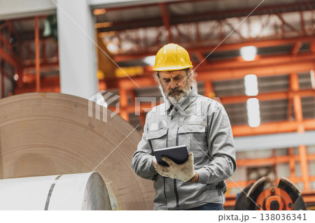 Senior staff worker in heavy industry, healthy elderly supervisor man work in metal sheet factory Senior staff worker in heavy industry, healthy elderly supervisor man work in metal sheet factory 138036341