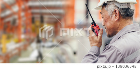Chief engineer man worker work control operate plant factory with hand held radio wide for banner 138036348