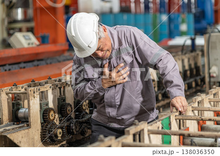 Senior factory worker chest pain suffering from heart attack, heart fail sign expression at work Senior factory worker chest pain suffering from heart attack, heart fail sign expression at work 138036350