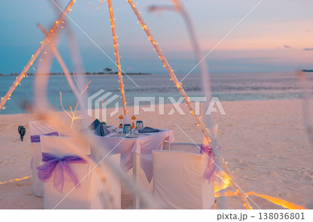 Sunset romantic beach dinner, vibrant colorful sky, ocean view, dreamy tropical vacation, couple getaway Sunset romantic beach dinner, vibrant colorful sky, ocean view, dreamy tropical vacation, couple getaway 138036801