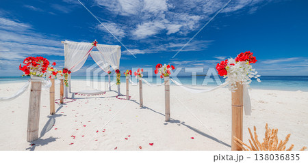 Tropical destination wedding on beach with floral arch candles and ocean view, white sand ceremony, sunny sky, romantic luxury vacation background 138036835