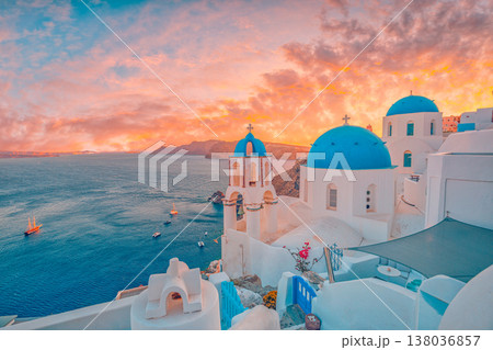 Stunning sunset Oia Santorini Greece, vibrant blue domes, romantic clouds, idyllic summer holiday, Mediterranean travel background 138036857
