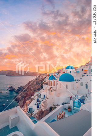 Sunset over Oia Santorini Greece, blue domes, romantic sky and clouds, picturesque Europe, summer vacation travel destination 138036858