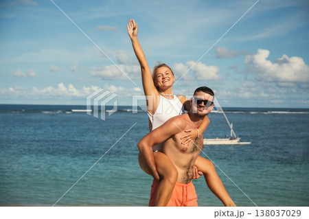 Couple enjoying fun and laughter on a sunny beach day Couple enjoying fun and laughter on a sunny beach day 138037029