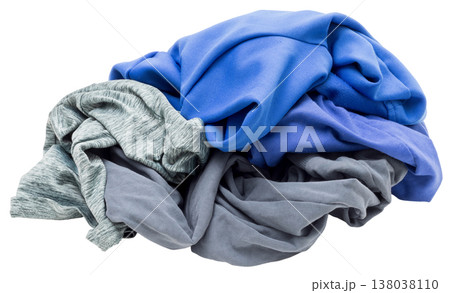 A messy heap of blue and gray clothing is placed on a clear surface. The wrinkled fabric suggests it has just come out of a laundry cycle, ready to be sorted or folded A messy heap of blue and gray clothing is placed on a clear surface. The wrinkled fabric suggests it has just come out of a laundry cycle, ready to be sorted or folded 138038110