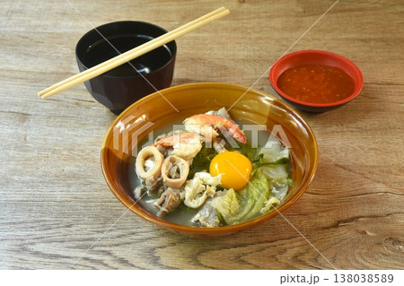 boiled sukiyaki seafood chicken and pork meat couple squid and shrimp with vegetable in soup on bowl dipping sauce boiled sukiyaki seafood chicken and pork meat couple squid and shrimp with vegetable in soup on bowl dipping sauce 138038589