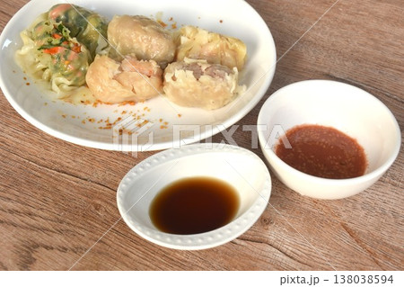 steamed Chinese dumpling stuffing shrimp and chop pork with vegetable on plate dipping soy sauce steamed Chinese dumpling stuffing shrimp and chop pork with vegetable on plate dipping soy sauce 138038594