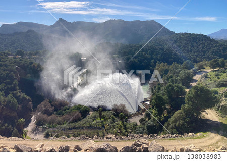 Dramatic emergency water release cascading from Guadalhorce reservoir after heavy rains creating powerful natural scenery in Spain. 138038983