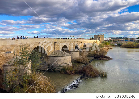 Ancient Roman bridge spanning the Guadalquivir River in Cordoba, Spain, at historic city center. Ancient Roman bridge spanning the Guadalquivir River in Cordoba, Spain, at historic city center. 138039246