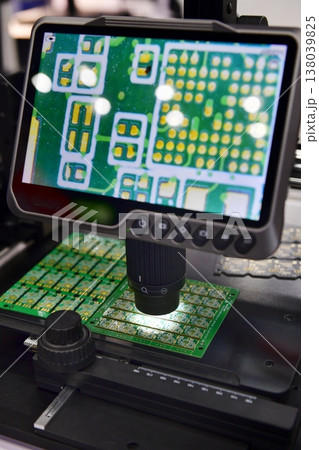 Digital microscope with LCD screen inspecting electronic circuit board in high resolution. 138039825