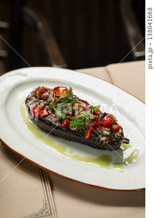 Roasted eggplant with herbs and chili on plate 138041668