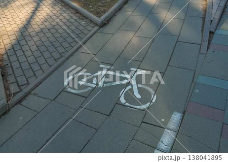 Bike Stencil On Sidewalk Directs Cyclists Along Designated Safe Pathways With Clear Signage Bike Stencil On Sidewalk Directs Cyclists Along Designated Safe Pathways With Clear Signage 138041895