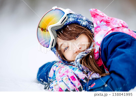 雪の上で寝そべる若い女性 138041995