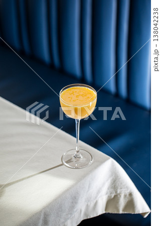 Orange cocktail in coupe glass on table 138042238
