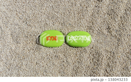 Beyond expectations words symbol. Concept words Beyond expectations on beautiful green stones. Beautiful sand background. Business and Beyond expectations words concept. Copy space. Beyond expectations words symbol. Concept words Beyond expectations on beautiful green stones. Beautiful sand background. Business and Beyond expectations words concept. Copy space. 138043233
