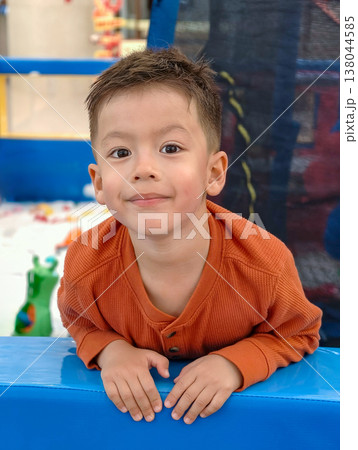 Happy multiracial boy enjoying playtime outdoors fun Happy multiracial boy enjoying playtime outdoors fun 138044585