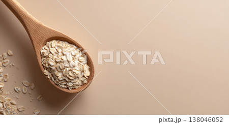 Wooden spoon with dry rolled oats Wooden spoon with dry rolled oats 138046052