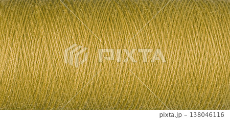 macro texture of a skein of yellow sewing thread macro texture of a skein of yellow sewing thread 138046116