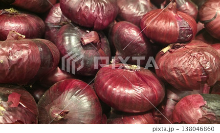 Fresh red onion close-up with natural texture and vibrant purple color 138046860