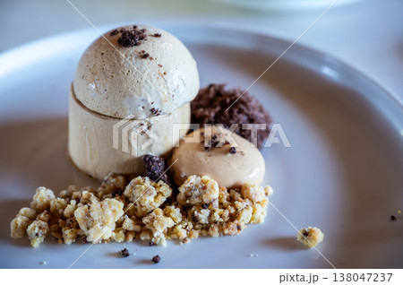Espresso parfait served on a white plate with a crumb topping, mocha mousse, and chocolate crumble, offering a delightful and gourmet culinary experience 138047237
