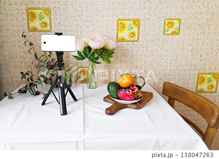 Content creation setup with smartphone, flowers, and fruits, lifestyle photography scene Content creation setup with smartphone, flowers, and fruits, lifestyle photography scene 138047263