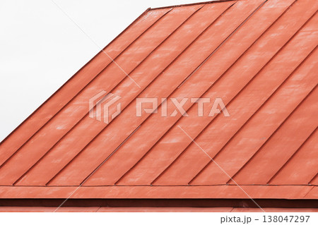 Close-up view of a red metal roof with diagonal panels 138047297