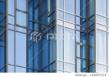Shiny blue glass facade of an office building, abstract photo Shiny blue glass facade of an office building, abstract photo 138047314