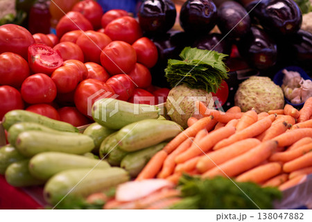 Fresh market vegetables with ripe tomatoes and carrots in colorful farmers market display Fresh market vegetables with ripe tomatoes and carrots in colorful farmers market display 138047882