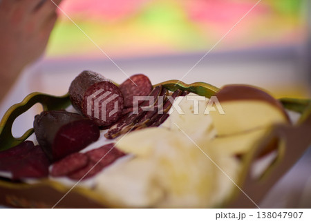 Charcuterie platter with sliced salami, cured meats and assorted cheeses on decorative tray 138047907