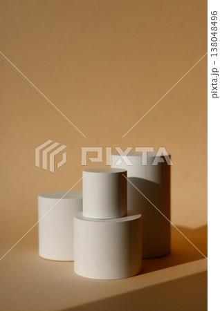 A beige background with a white podium for copy space items or cosmetics. A beige background A beige background with a white podium for copy space items or cosmetics. A beige background 138048496