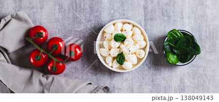 A bowl of mozzarella balls and spinach on the table top view web banner A bowl of mozzarella balls and spinach on the table top view web banner 138049143