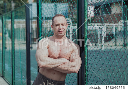 A CrossFit man poses for the camera on a sports A CrossFit man poses for the camera on a sports 138049266