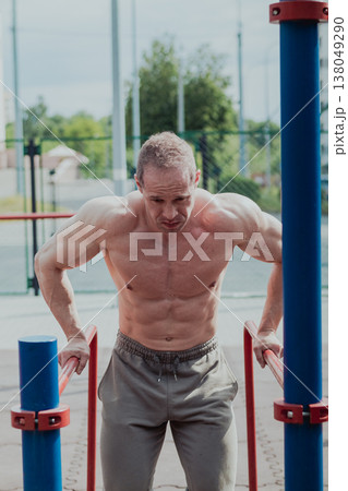 A CrossFit man poses for the camera on a sports A CrossFit man poses for the camera on a sports 138049290