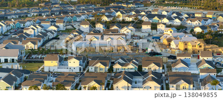 Wooden frames of new cheap American homes under construction. Development of residential housing in the USA Wooden frames of new cheap American homes under construction. Development of residential housing in the USA 138049855