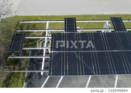 Wind damage to solar panels installed over parking lot canopy shade for parked cars for effective generation of clean energy 138049864