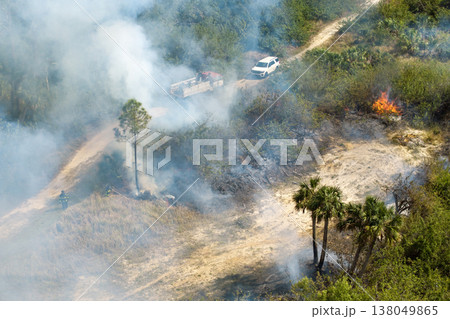 Wild vegetation fire spreads across forested landscape in Florida, filling air with thick smoke and intense heat during dry season Wild vegetation fire spreads across forested landscape in Florida, filling air with thick smoke and intense heat during dry season 138049865