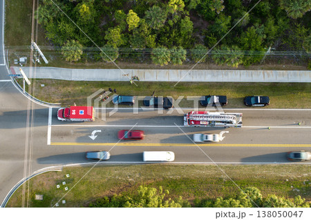Traffic accident on American street in Florida. First responders helping victims of car crash on road in USA. Aerial view of emergency services responding to accident site 138050047
