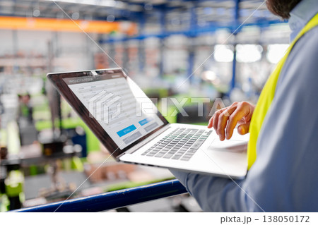 Close up of factory manager with laptop in industrial factory. Close up of factory manager with laptop in industrial factory. 138050172