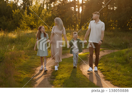 Gentle Twilight Ambiance With Kin Wandering Down Rural Track Casting Extended Silhouettes 138050886