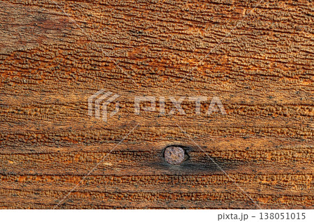 Detailed wooden surface with visible nail and strong grain texture, rustic abstract background, aged material with industrial character for design and construction concept Detailed wooden surface with visible nail and strong grain texture, rustic abstract background, aged material with industrial character for design and construction concept 138051015